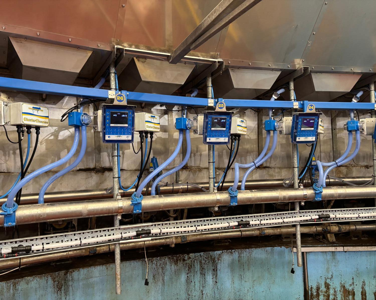 New cluster-cleaning units, control boxes and pipework on a rotary milking parlour fitted by Colin Dawson Ltd