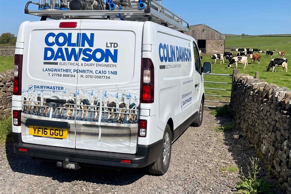 Colin Dawson Ltd van with milking equipment loaded on the roof rack at a farm gate
