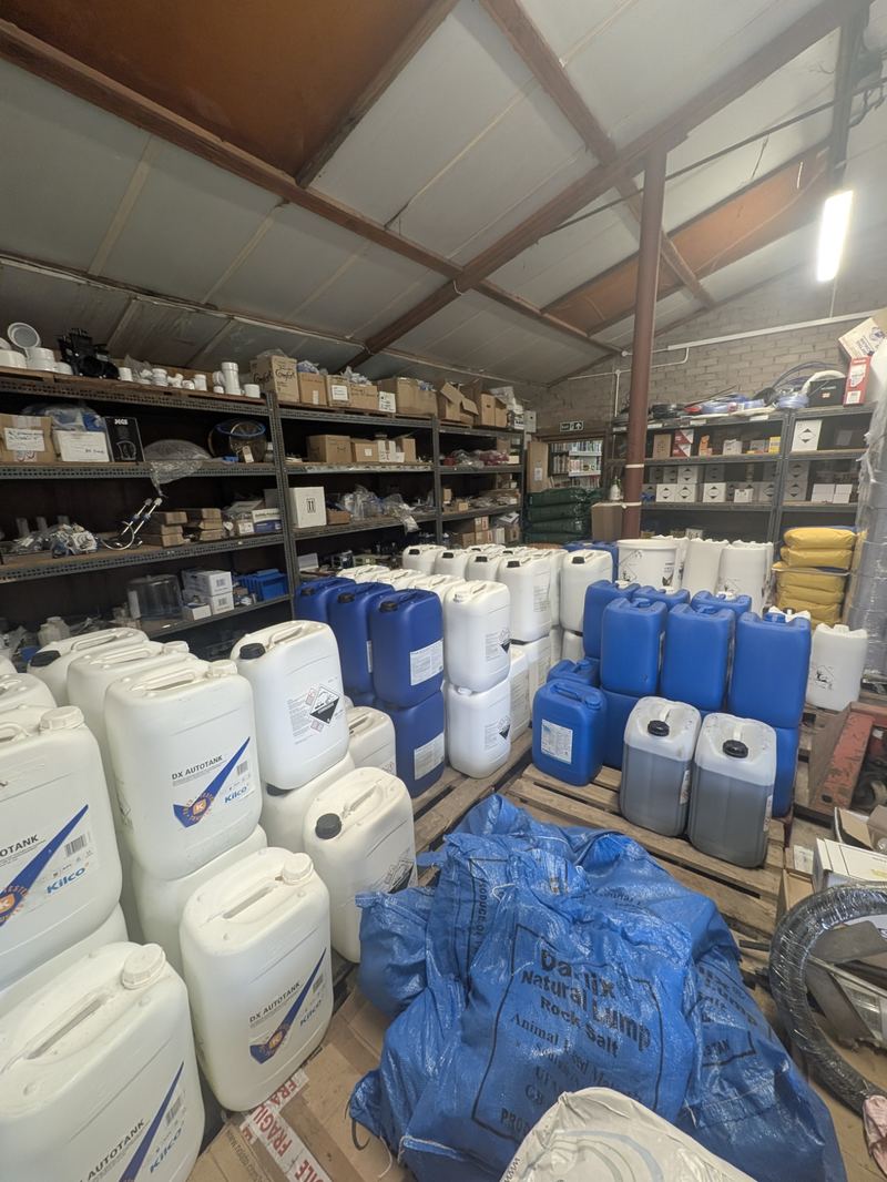 Drums of dairy hygiene chemicals and parlour consumables in the store