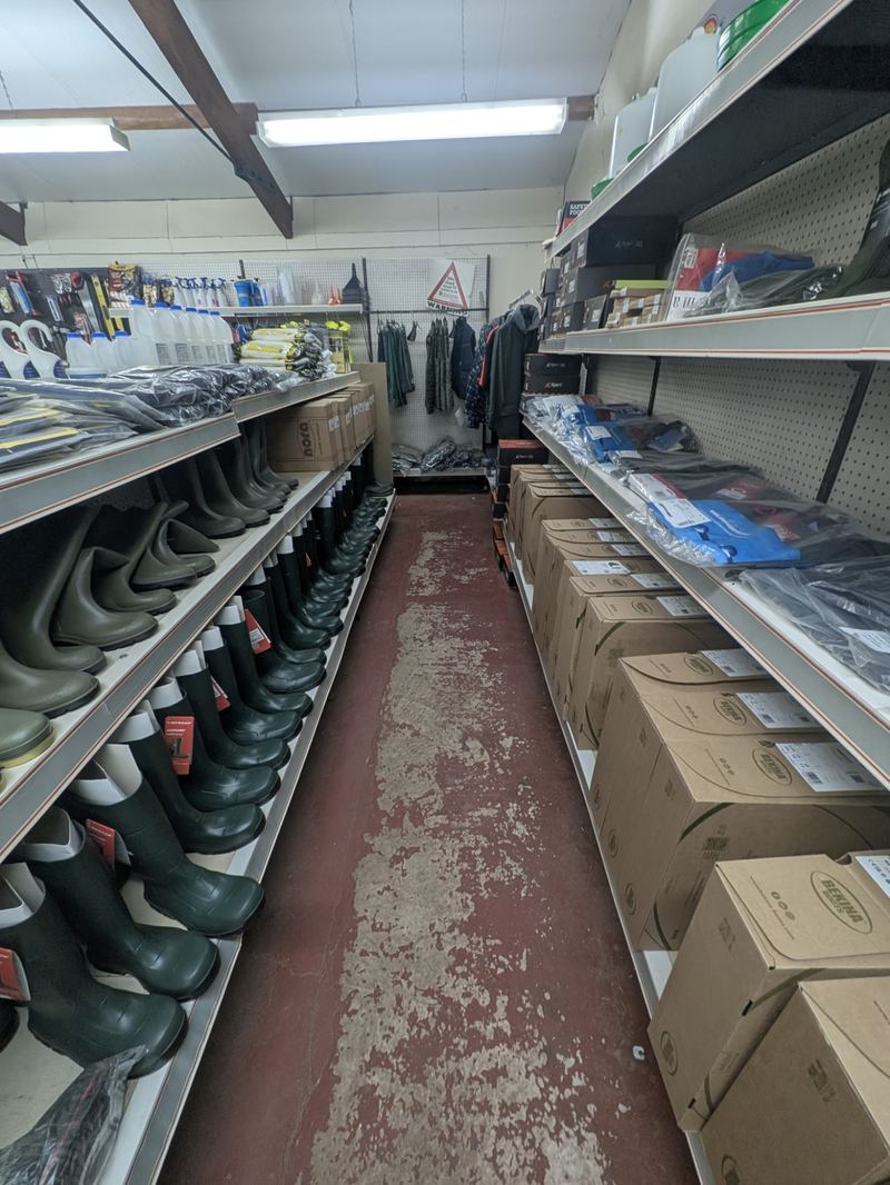 Wellington boots, workwear and hardware on the shelves of the store
